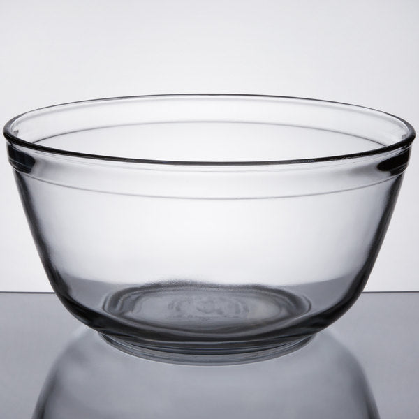 4 quart glass mixing bowl sitting on a stainless steel table with a white background
