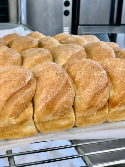 della rolls are white dinner rolls with butter baked into the center and drizzled on top copyrighted image