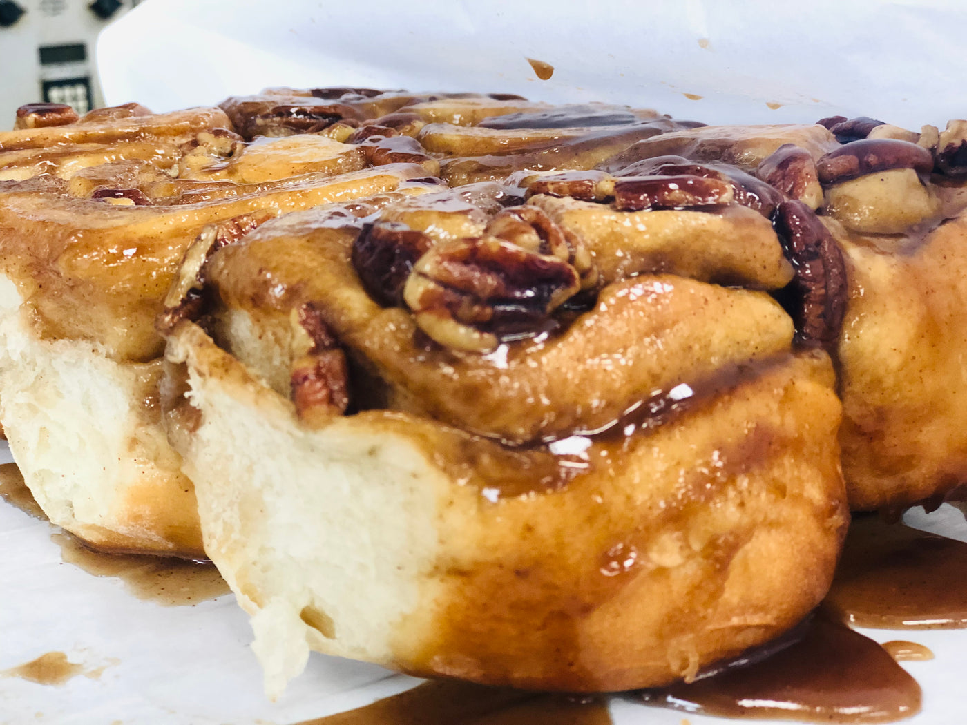 close up of a pecan sticky buns with pecans and caramel sauce