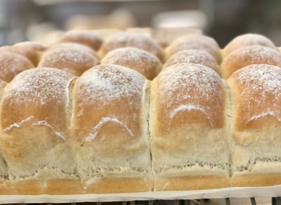 close up Bread Brothers Bakery white dinner rolls with flour dusted on top copyrighted image