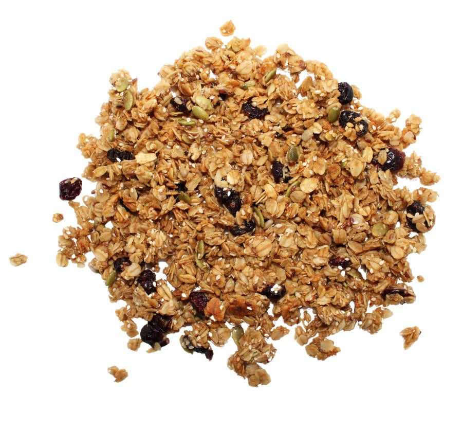 a portion of clean cranberry granola with sunflower, sesame, pumpkin and flax seeds on a white background