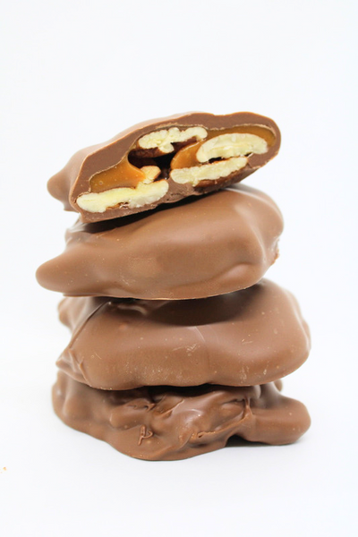 Bread Brothers Bakery pecan turtles milk chocolate stack of four. Copyrighted image.