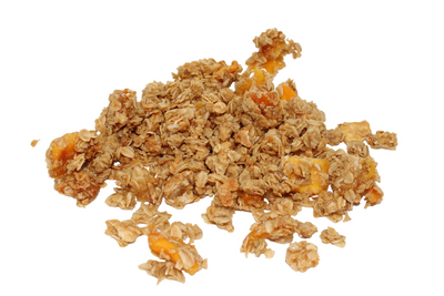 spill view of a portion of tropical granola with mango, coconut and pineapple on a white background